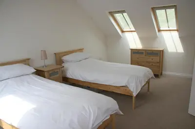 two beds in a room with two windows at Rocksalt in Saint Minver