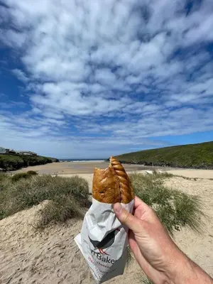 a person holding a piece of food in their hand at Rocksalt in Saint Minver