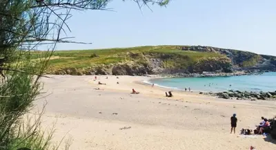 a group of people on a beach near the water at Sun Trap Terrace in Porthleven