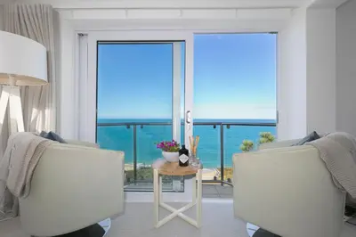 a living room with a view of the ocean at Coastal Breeze in Carbis Bay