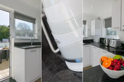 two pictures of a kitchen with a bowl of fruit at Coastal Breeze in Carbis Bay