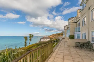 a balcony with a view of the ocean at Coastal Breeze in Carbis Bay