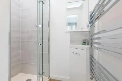 a shower with a glass door in a bathroom at Coastal Breeze in Carbis Bay