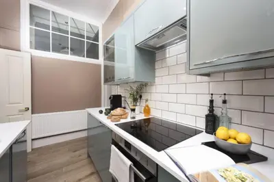 a kitchen with a counter with a bowl of fruit at The Secret Seascape - Free Parking - Free WiFi - Carbis Bay in Carbis Bay