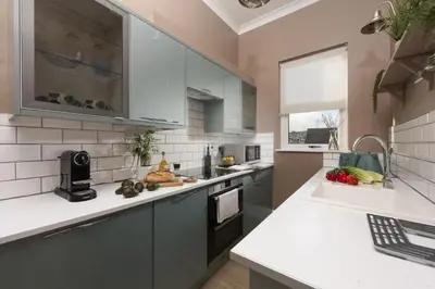 a kitchen with white cabinets and a counter top at The Secret Seascape - Free Parking - Free WiFi - Carbis Bay in Carbis Bay
