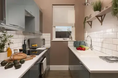 a kitchen with a sink and a counter with vegetables on it at The Secret Seascape - Free Parking - Free WiFi - Carbis Bay in Carbis Bay