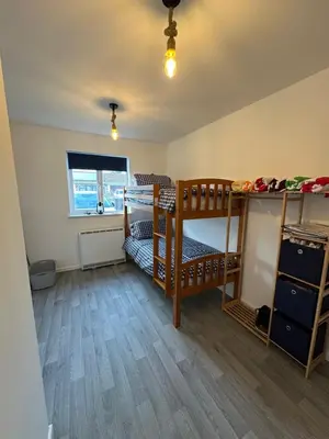 a bedroom with two bunk beds and a window at The White House in St Merryn