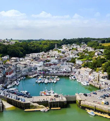 an aerial view of a harbor with boats in the water at The White House in St Merryn