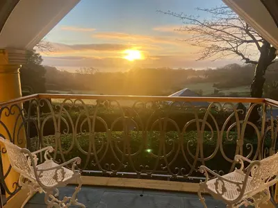 a view of the sunset from a balcony at Hunters Moon in St Austell