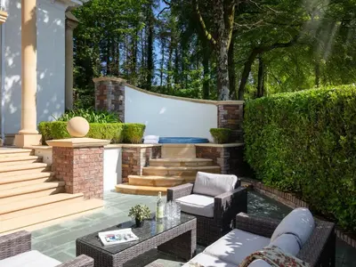 a patio with a couch and chairs and a table at Hunters Moon in St Austell