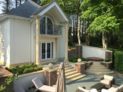 a home with a patio with chairs and a table at Hunters Moon in St Austell
