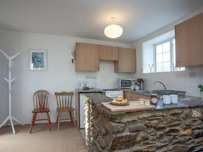 a kitchen with a stone counter top in a room at Hayloft - Uk48766 in Looe