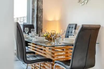 a dining room with a table with chairs and wine glasses at 3 Bed in Delabole oc-t30590 in Delabole
