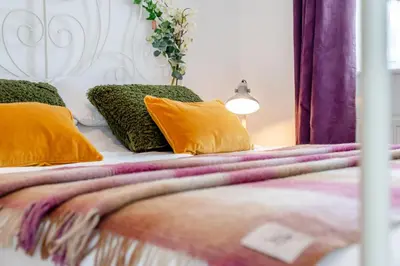 a bedroom with a bed with yellow pillows at 3 Bed in Delabole oc-t30590 in Delabole