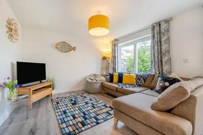 a living room with a couch and a tv at 3 Bed in Delabole oc-t30590 in Delabole