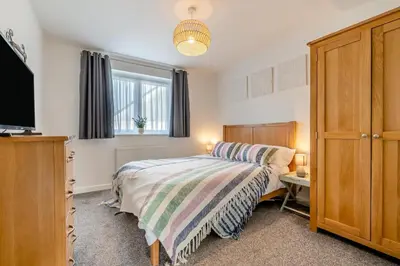 a bedroom with a bed and a tv and a window at 3 Bed in Delabole oc-t30590 in Delabole