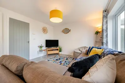 a living room with a couch and a tv at 3 Bed in Delabole oc-t30590 in Delabole
