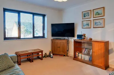 a living room with a flat screen tv at Finest Retreats - Tregenna Court in Falmouth