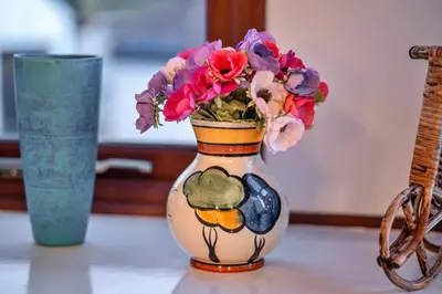 a vase with flowers in it sitting on a table at Finest Retreats - Tregenna Court in Falmouth