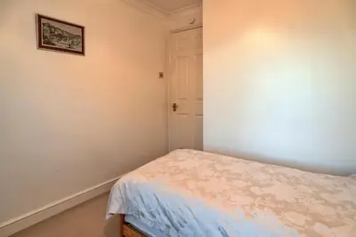 a bedroom with a bed and a picture on the wall at Finest Retreats - Tregenna Court in Falmouth
