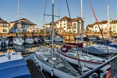 a group of boats docked in a marina with houses at Finest Retreats - Tregenna Court in Falmouth