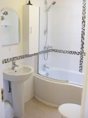 a bathroom with a tub and a sink and a shower at Cottage in Crantock, seaviews, 10min walk to beach in Crantock