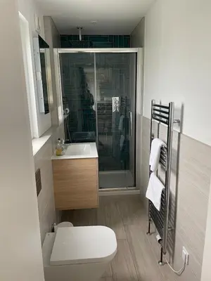 a bathroom with a shower and a toilet and a sink at Cottage in Crantock, seaviews, 10min walk to beach in Crantock