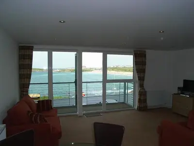a living room with a view of the ocean at Fistral View Apartment in Newquay