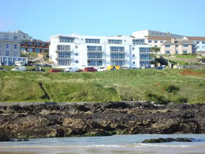 a view of a beach with buildings in the background at Fistral View Apartment in Newquay