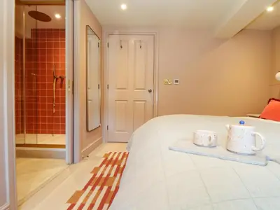 a bedroom with a bed with two mugs on it at Mavericks Wave in St. Agnes