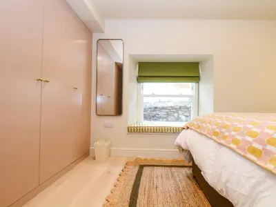 a bedroom with a bed and a window at Mavericks Wave in St. Agnes