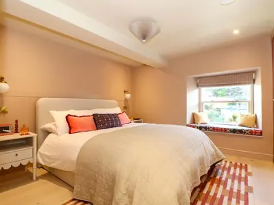 a bedroom with a bed and a window at Mavericks Wave in St. Agnes