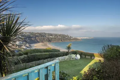 a balcony with a view of a beach and the ocean at 3 Pentowan Court, Carbis Bay in Carbis Bay