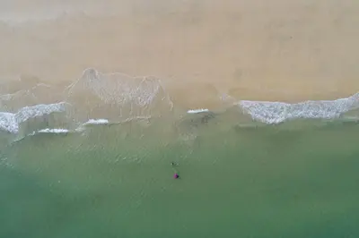 an aerial view of the ocean with a person in the water at 3 Pentowan Court, Carbis Bay in Carbis Bay