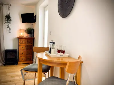 a dining room table with two chairs and a blender on it at The Studio in Bude