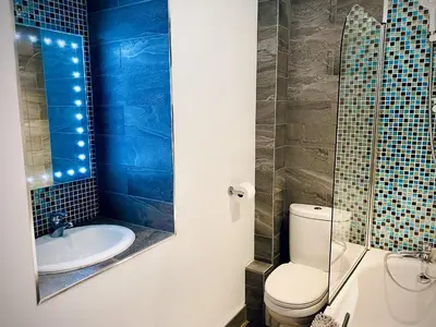 a bathroom with a toilet and a sink at The Studio in Bude