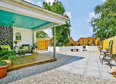 a backyard with a wooden deck and a fence at The Studio in Bude