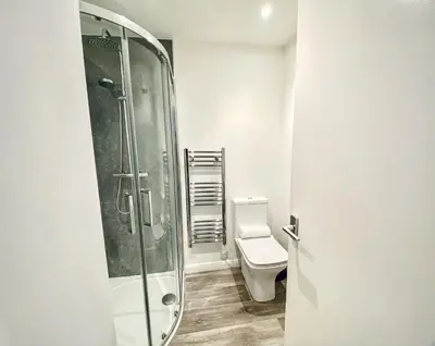 a bathroom with a shower and a toilet at Trelawne in Bude