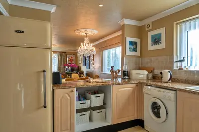 a kitchen with a white refrigerator and a dishwasher at Finest Retreats - Harvest Moon in Newquay
