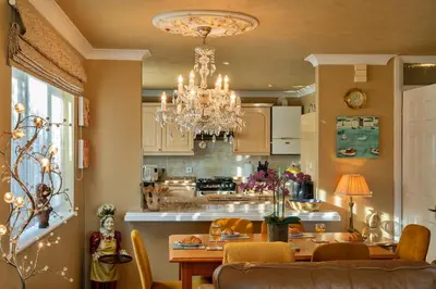 a dining room and kitchen with a chandelier at Finest Retreats - Harvest Moon in Newquay