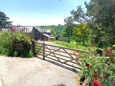 a wooden fence in a garden with flowers at 2 Bed in St. Mawgan oc-l30651 in Saint Mawgan