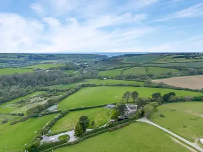 an overhead view of a green field with trees and houses at 2 Bed in St. Mawgan oc-l30651 in Saint Mawgan