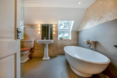 a bathroom with a large white tub and a sink at 2 Bed in St. Mawgan oc-l30651 in Saint Mawgan