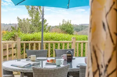 a table with a plate of food and an umbrella at 2 Bed in Mawgan oc-c30671 in Mawgan