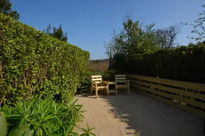 a patio with two chairs and a table at 2 Bed in Mawgan oc-c30671 in Mawgan