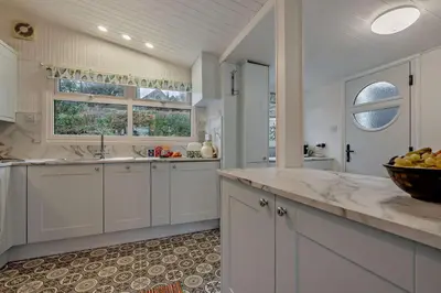 a kitchen with white cabinets and a bowl of fruit on the counter at 2 Bed in Mawgan oc-c30671 in Mawgan