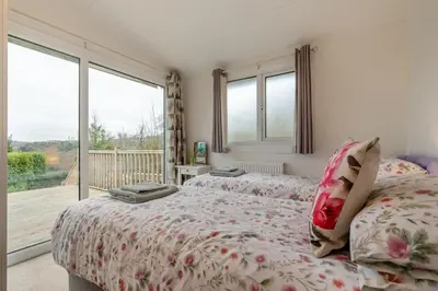 two beds in a bedroom with a balcony at 2 Bed in Mawgan oc-c30671 in Mawgan