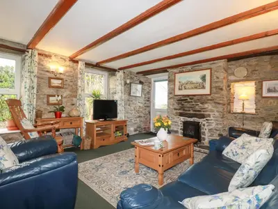 a living room with a couch and a fireplace at Bramble Cottage in Hayle