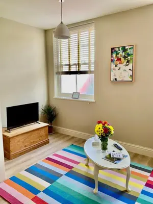a living room with a table and a tv at Apartment in Constantine in Constantine