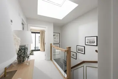 a skylight in a white living room with a skylight at Harlyn Folly, Apartment 6, Harlyn in St Merryn
